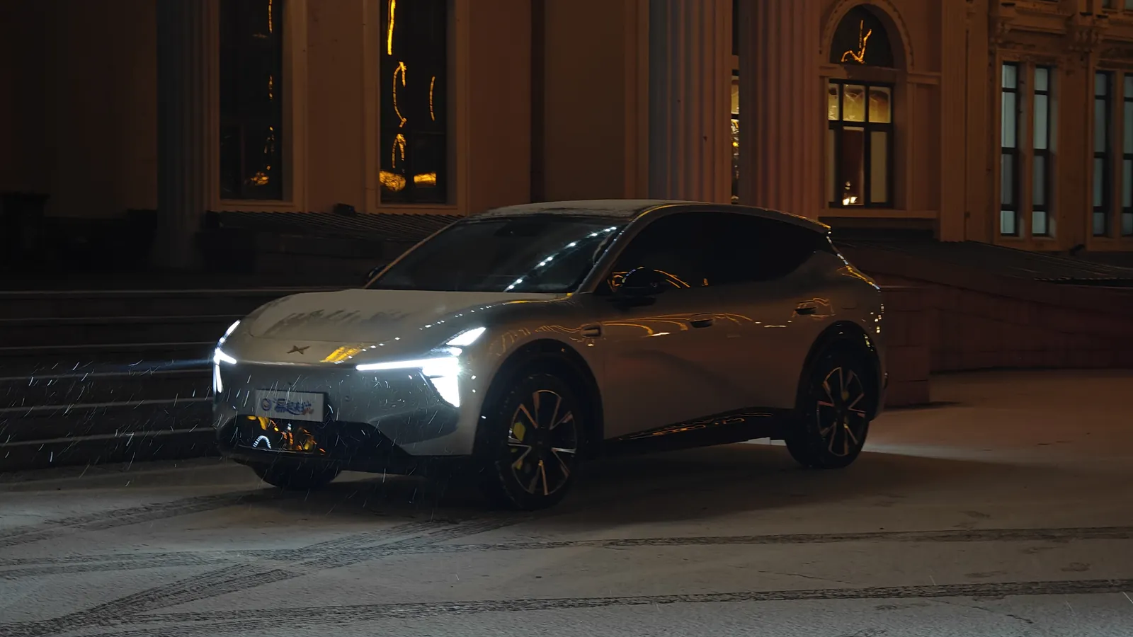 The MONA L05 at night in front of a historic building
